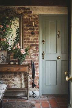 an entryway with a bench, mirror and flowers on the door sill in front of it