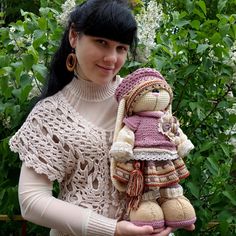 a woman holding a stuffed animal in her hands