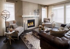 a living room filled with furniture and a fire place in the middle of the room