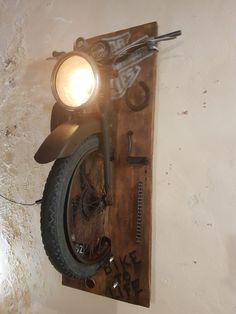 a motorcycle is mounted to the wall with a light on it