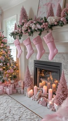 a living room decorated for christmas with pink decorations and stockings on the fireplace mantel