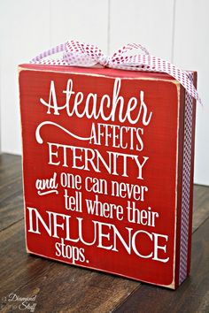 a red box with white lettering on it and a bow tied around the top that says, teacher affects eternity and one can never tell if