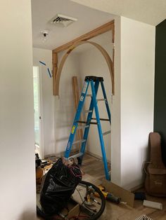 a room that is being remodeled with some tools on the floor and ladders in front of it