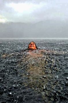 a woman floating in the water with her eyes closed