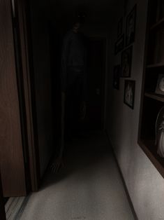 a creepy looking person standing in the hallway at night with his hand on the floor