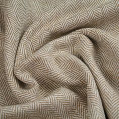 a close up view of a tan and white checkered fabric with an interesting pattern