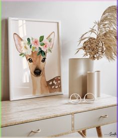 a deer with flowers on it's head sitting next to a pair of glasses