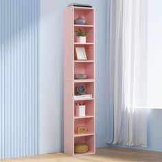 a pink bookcase in the corner of a room