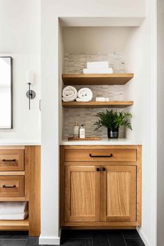 a bathroom with wooden cabinets and white towels