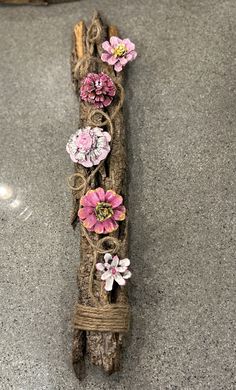 a piece of driftwood with flowers on it