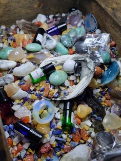 a bin filled with lots of different colored rocks