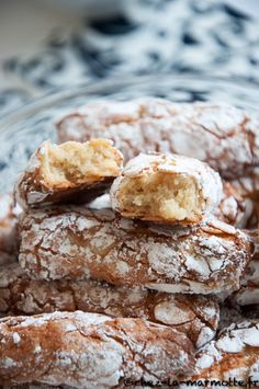 powdered sugar cookies stacked on top of each other in a glass bowl with black and white lace