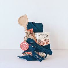 a wooden spoon sitting on top of a bag filled with blue cloth and other items