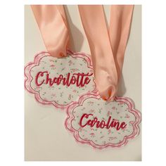 two tags with the words chocolate and cookie on them hanging from pink satin ribbones