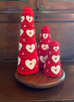 three red knitted cones with hearts on them