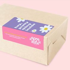 a pink and white box with some flowers on it