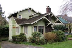 a green house sitting on the side of a road