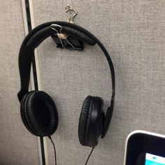 headphones hanging on the wall next to a cell phone