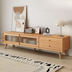 a living room scene with focus on the sideboard and rug in the foreground