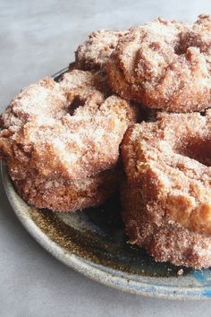 some sugared donuts are on a plate