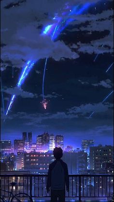 a man looking at fireworks in the sky