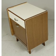 a small wooden cabinet with two drawers