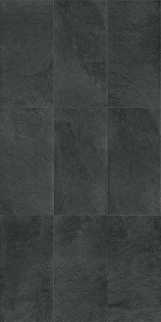 a black tile wall with different shades of gray and white tiles on it's sides