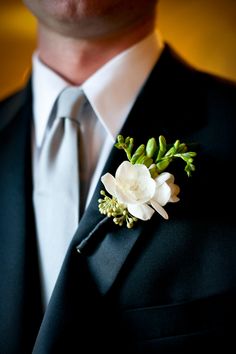 a man in a suit with a boutonniere on his lapel