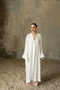 Introducing our stunning White Abaya, a true embodiment of elegance and style. ■ This exquisite WHITE KAFTAN dress and white maxi dress is expertly crafted from premium viscose fabric, known for its exceptional quality and luxurious feel. The unobtrusive and laconic embroidery, delicately made with silk threads, adds a touch of sophistication and refinement to this timeless piece. The pristine white color enhances its elegance, making it a versatile choice for any occasion. ■ Designed with versa Elegant White Floor-length Kimono, Elegant Long Sleeve Summer Abaya, Summer Wedding Floor-length Abaya, Elegant Maxi Length Summer Thobe, Elegant Summer Maxi Thobe, Elegant Summer Maxi-length Thobe, White Oversized Maxi Dress, Elegant Summer Abaya, Summer Wedding Long Abaya