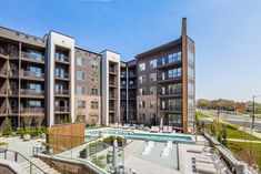 an apartment complex with swimming pool and patio furniture