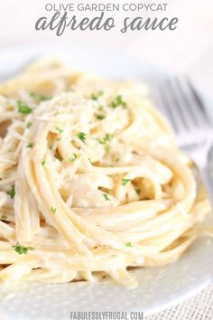 a white plate topped with pasta covered in parmesan cheese and garnished with parsley