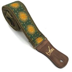 a brown and green belt with yellow sunflowers on the front, in gold lettering