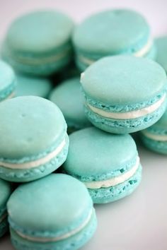 an image of blue macarons with white frosting on them and the words turquose and white macaroons