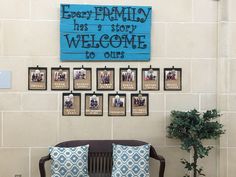 there is a couch with many pictures on the wall behind it and a sign that says every family has a story welcome to ours