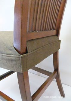 a wooden chair with a gray cushion on it