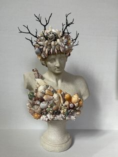 a statue with many shells on it's head