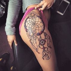 a woman's thigh with a tattoo on it and an image of a dream catcher