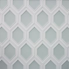 a white and gray wall with hexagonal shapes