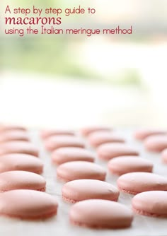 pink macarons sitting on top of a white tray with the words, a step by step guide to macarons using the italian meringue method