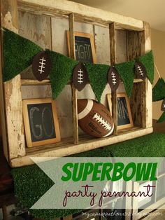 an old window is decorated with footballs and grass for a super bowl party decoration