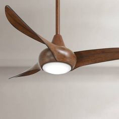 a ceiling fan with wooden blades and a white light