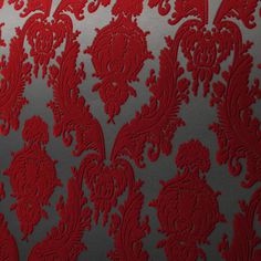 red and silver wallpaper with an intricate design on the back side, in shades of grey