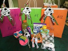 several bags with different items on them sitting on a table in front of some paper bags