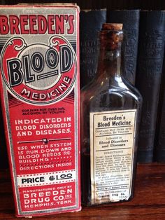 a bottle of blood medicine sitting on top of a wooden table