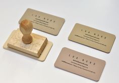 three business cards with a rubber stamp on them