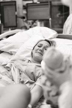 a woman laying in a hospital bed with her eyes closed