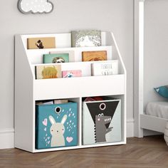 a white book shelf filled with books and toys