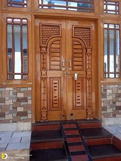 two wooden doors with windows and steps leading up to them