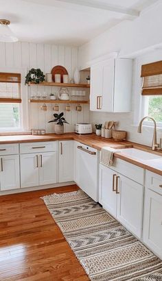 the kitchen is clean and ready for us to use it's counters are white with wood trim