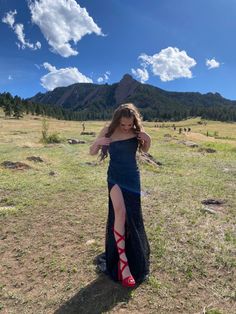 a woman in a long dress standing on the ground